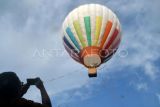 Pengunjung merekam video balon udara terbang di Melrimba Resto Garden, Cisarua, Kabupaten Bogor, Jawa Barat, Senin (5/5/2025). Wisata balon udara yang pertama kali hadir di kawasan Puncak, Bogor tersebut menjadi tempat favorit bagi pengunjung menyaksikan panorama Puncak, Bogor di ketinggian 50 meter dengan durasi 15 menit dan harga Rp850 ribu per orang. ANTARA FOTO/Arif Firmansyah/foc.