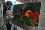 Seorang penyandang  disabilitas menyelesaikan lukisan burung pada kain kanvas di Sekolah Luar Biasa (SLB)  Yayasan Pendidikan Disabilitas Insani, Jaya Baru, Banda Aceh, Aceh, Jumat (9/5/2025). SLB Yayasan Disabilitas yang menerapkan 70 persen pendidikan vokasi dan 30 persen pendidikan akademik pada  murid disabilitas  itu untuk mempersiapkan generasi muda mandiri dengan berbagai keterampilan yang siap untuk memasuki pasar tenaga kerja. ANTARA FOTO/Ampelsa.