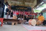 Sejumlah warga Suku Osing memainkan musik tradisional Gedhogan di Jopuro, Banyuwangi, Jawa Timur, Sabtu (10/5/2025). Permainan musik tradisional yang dimainkan oleh warga lanjut usia menggunakan lesung dan alu (penumbuk padi) dipadukan dengan kendang tersebt masih dilestarikan masyarakat Suku Osing sebagai upaya kelestarian budaya ditengah arus modernisasi. ANTARA Jatim/Budi Candra Setya/mas.