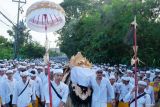 Ribuan umat Hindu beriring-iringan berjalan kaki dengan membawa benda sakral menuju Pura Uluwatu saat rangkaian upacara Masupati Sesuhunan Ida Bhatara Dewa Ayu di Badung, Bali, Minggu (11/5/2025). Upacara sakral yang digelar Desa Adat Jimbaran pada 11-12 Mei 2025 tersebut diikuti sekitar 25 ribu umat Hindu dengan menempuh perjalanan sepanjang 15 km. ANTARA FOTO/Nyoman Hendra Wibowo/wsj.