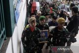 Prajurit TNI membawa foto dan peti jenazah almarhum Mayor (Cpl) Anda Rohanda sebelum prosesi upacara pemakaman militer di pemakaman keluarga, Cinunuk, Kabupaten Bandung, Jawa Barat, Selasa (13/5/2025). Prajurit Gupusmu III Jakarta tersebut merupakan salah satu dari 13 korban jiwa dalam musibah ledakan saat pemusnahan amunisi tidak layak pakai di Desa Sagara, Kecamatan Cibalong, Kabupaten Garut pada Senin (12/5) lalu. ANTARA FOTO/Novrian Arbi/agr