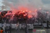 Pendukung menyalakan suar saat pertandingan antara Persita Tangerang melawan Persib Bandung pada pertandingan BRI Liga 1 2024/2025 di Stadion Indomilk Arena, Kabupaten Tangerang, Banten, Jumat (16/5/2025). Pertandingan tersebut sempat terhenti di menit 79 karena pendukung menyalakan suar dan petasan. ANTARA FOTO/Galih Pradipta