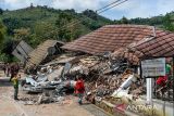 Warga berada di depan bangunan yang runtuh akibat longsor di Desa Kendan, Kecamatan Nagreg, Kabupaten Bandung, Jawa Barat, Senin (19/5/2025). Longsor yang terjadi pada Minggu 18/5 malam tersebut mengakibatkan kompleks kantor dan fasilitas desa serta satu rumah warga rusak berat dan tiga orang mengalami luka-luka. ANTARA FOTO/Raisan Al Farisi/agr