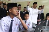 Menteri Sosial (kanan) melihat proses Simulasi Pembelajaran Sekolah Rakyat di Internasional Islamic Boarding School (IBBS) Al Hikmah, Batu, Jawa Timur, Senin (19/5/2025).  Simulasi tersebut diadakan untuk mengenalkan sekaligus memberi gambaran kepada calon siswa sekolah rakyat mengenai sistem pembelajaran serta kurikulum yang nantinya akan diajarkan. ANTARA Jatim/Ari Bowo Sucipto/mas.