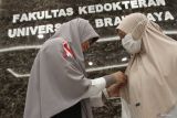 Dokter mengenakan pita merah putih saat mengikuti Aksi Terbuka di gedung Graha Medika, Universitas Brawijaya, Malang, Jawa Timur, Selasa (20/5/2025). Mereka meminta pemerintah mewujudkan kemitraan sejajar antara Kementerian Kesehatan, Kementerian Pendidikan Tinggi Sains Riset Teknologi, Rumah Sakit Pendidikan maupun institusi pendidikan kedokteran serta mengembalikan fungsi kolegium sebagai badan yang dibentuk organisasi profesi kedokteran guna menyusun standar kompetensi dan kurikulum untuk tenaga kesehatan sekaligus memastikan kualitas pendidikan kesehatan. ANTARA Jatim/Ari Bowo Sucipto/mas.