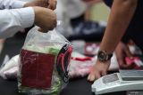 Polisi menata barang bukti narkoba saat rilis kasus penyalahgunaan dan peredaran narkoba di Polda Jawa Timur, Surabaya, Jawa Timur, Rabu (21/5/2025). Ditresnarkoba Polda Jawa Timur menangkap empat orang di lokasi berbeda dan telah ditetapkan sebagai tersangka dalam kasus dugaan penyalahgunaan dan peredaran narkoba dengan mengamankan sejumlah barang bukti dari empat tersangka itu di antaranya narkoba jenis sabu seberat total 9,5 kilogram, pil ekstasi sebanyak 5.814 butir dan sejumlah sarana pengirimannya. Antara Jatim/Didik Suhartono/um 