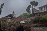 Warga berjalan di dekat material tanah longsor yang menimpa rumah di Kampung Pencut, Lembang, Kabupaten Bandung Barat, Jawa Barat, Sabtu (24/5/2025). Berdasarkan data BPBD Kabupaten Bandung Barat, sebanyak enam rumah rusak ringan hingga berat terdampak bencana longsor pada Jumat (23/5) yang terjadi akibat tingginya intensitas hujan. ANTARA FOTO/Abdan Syakura/agr
