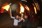Sejumlah anak membawa obor saat takbir keliling di Kelurahan Lirboyo, Kota Kediri, Jawa Timur, Kamis (5/6/2025). Tradisi takbir keliling mengitari kampung tersebut guna menyambut datangnya Idul Adha 1446 Hijriah. Antara Jatim/Prasetia Fauzani/um