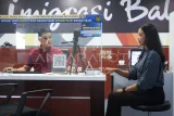 Pemohon pembuatan paspor elektronik (e-paspor) memindai sidik jari di Kantor Imigrasi Kelas I TPI Balikpapan, Kalimantan Timur, Kamis (3/7/2025). Kantor Imigrasi Kelas I TPI Balikpapan mencatat telah menerbitkan 7.852 paspor elektronik dan 4.614 paspor biasa sepanjang Januari hingga Juni, dengan mayoritas permintaan untuk perjalanan ibadah umrah, wisata, dan pengobatan ke luar negeri. Antara Kaltim/Aditya Nugroho/mrh