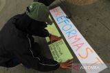 Seorang mahasiswa menyusun poster-poster saat mengikuti Aksi Kamisan Pontianak #60 di Taman Digulis Universitas Tanjungpura, Pontianak, Kalimantan Barat, Kamis (3/7/2025). Dalam aksi tersebut mereka menyerukan isu reformasi Polri dan mendesak pemerintah menuntaskan kasus-kasus pelanggaran HAM yang terjadi di Indonesia. ANTARA FOTO/Jessica Wuysang