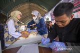 Petugas menyuntikkan vaksin rabies ke seekor kucing di Alun-alun Indramayu, Jawa Barat, Rabu (23/7/2025). Dinas Ketahanan Pangan dan Pertanian (DKPP) Kabupaten Indramayu menggelar vaksinasi rabies gratis bagi hewan peliharaan untuk mencegah penyebaran rabies pada hewan peliharaan, dan mengurangi risiko penularannya ke manusia serta memberikan edukasi kepada masyarakat pentingnya menjaga kesehatan hewan peliharaan. ANTARA FOTO/Dedhez Anggara/agr