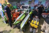 Pengunjung mengamati mesin panen jagung yang dipamerkan pada Gelar Inovasi dan Teknologi Pertanian di Kabupaten Kediri, Jawa Timur, Rabu (30/7/2025). Gelar Inovasi dan Teknologi Pertanian selama tiga hari tersebut mengundang sedikitnya 2400 petani dan melibatkan 41 perusahaan yang bergerak dalam bidang pembenihan, pupuk, peptisida, dan alat mesin pertanian sebagai upaya mendorong kemajuan sektor pertanian. Antara Jatim/Prasetia Fauzani/um