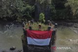 Anggota Forum Komunitas Pecinta Alam Tasikmalaya (FKPAT) membentangkan bendera merah putih saat acara Temu Akrab Pecinta Alam (TAPA) di Jembatan Perjuangan Karang Resik, Kota Tasikmalaya, Jawa Barat, Minggu (10/8/2025). Pembentangan bendera merah putih yang digelar FKPAT, TCC, dan Republik Aer itu dalam rangka menyemarakkan HUT Ke-80 R sekaligus mengenang jasa pahlawan yang menghadang penjajah saat agresi militer Belanda I pada 7 Agustus 1947 di jembatan tersebut. ANTARA FOTO/Adeng Bustomi/agr
