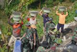 Angkut kerikil dan pasir  di kepala demi jalan beton di lereng sumbing