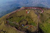 Sejumlah pendaki mengikuti upacara bendera yang diselenggarakan TSA Indonesia di kawasan Puncak Pawitra Gunung Penanggungan, Kabupaten Mojokerto, Jawa Timur, Minggu (17/8/2025). Sekitar lima ribu pendaki dari berbagai daerah melakukan pendakian dan mengikuti upacara memperingati HUT ke-80 RI di gunung tersebut dengan membentangkan bendera Merah Putih sepanjang seribu meter. Antara Jatim/Muhammad Mada/um