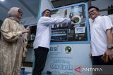 Direktur Utama Bank Syariah Indonesia (BSI) Anggoro Eko Cahyo (tengah) disaksikan SEVP Pengembangan Produk Niaga PLN Ririn Rachmawardhini (kiri) dan Chief Operating Officer PT Plasticpay Teknologi Daurulang Yan Kurniawan Setiadi (kanan) memasukkan botol plastik ke dalam mesin saat peluncuran Stasiun Pengisian Kendaraan Listrik Umum (SPKLU) dan Reverse Vending Machine (RVM) di Masjid Raya Bintaro Jaya, Kota Tangerang Selatan, Banten, Jumat (5/9/2025). BSI meluncurkan SPKLU dan RVM untuk mendukung gerakan ekonomi hijau di lingkungan berbasis komunitas masjid. ANTARA FOTO/Putra M. Akbar/gp