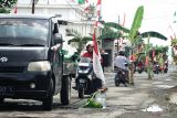 Pengendara melintasi jalan yang ditanami pohon pisang di Ngunut, Tulungagung, Jawa Timur, Senin (15/9/2025). Jalan alternatif penghubung antarkecamatan itu ditanami pohon pisang dan aneka penanda lain karena kondisinya yang rusak parah (berlubang) sehingga beberapa kali memicu kecelakaan lalu lintas. Antara Jatim/Destyan Sujarwoko/um