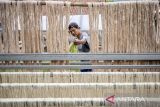 Pekerja menjemur serat daun nanas di rumah produksi Alfiber Serat Daun Nanas Subang di Cijambe, Kabupaten Subang, Jawa Barat, Kamis (18/9/2025). Rumah produksi yang memberdayakan masyarakat sekitar tersebut dalam satu bulan mampu mengolah 3,2 ton limbah daun nanas menjadi 50-60 kilogram serat daun nanas yang kemudian dijadikan benang dan selendang serta berbagai produk eco-fashion seperti topi, tas makrame, dompet dan pernak-pernik lainnya yang telah diekspor ke Singapura, Malaysia, Jepang, Jerman dan Belanda, sekaligus dipasarkan ke berbagai daerah di Indonesia dengan harga mulai dari Rp95 ribu hingga Rp600 ribu. ANTARA FOTO/Abdan Syakura/agr