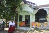 Siswa berjalan di depan ruang perpustakaan yang rusak di SDN 2 Bugeman, Desa Bugeman, Kendit, Situbondo, Jawa Timur, Senin (22/9/2025). Siswa kelas V dan VI di sekolah tersebut terpaksa belajar di ruang kelas yang rusak selama enam tahun terakhir ini dan belum pernah ada perbaikan. Antara Jatim/Seno/um