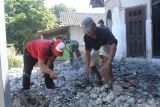 Anggota TNI, Polri, dan relawan membersihkan reruntuhan rumah terdampak gempa di Desa Sumberwaru, Banyuputih, Situbondo, Jawa Timur, Jumat (26/9/2025). Badan Meteorologi, Geofisika, dan Klimatologi (BMKG) melaporkan gempa yang terjadi, Kamis (25/9) sore dengan pusat gempa bermagnitudo 5,7 ini 46 kilometer timur laut Banyuwangi, dengan kedalaman 12 kilometer dan tidak berpotensi tsunami. Antara Jatim/Seno/um