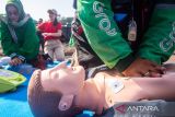 Warga dan pengemudi ojek online berlatih pertolongan kompresi dada saat mengikuti pelatihan bantuan hidup dasar di Lapangan Saparua, Bandung, Jawa Barat, Minggu (28/9/2025). Perhimpunan Dokter Spesialis Kardiovaskular Indonesia (PERKI) Bandung memberikan pelatihan kepada masyarakat dan pengemudi ojek online berupa cek kesadaran, kompresi dada hingga pertolongan saat tersedak guna meningkatkan kesadaran tentang pentingnya kesehatan jantung serta keterampilan pertolongan pertama dalam situasi darurat. ANTARA FOTO/Novrian Arbi/agr