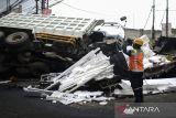 Petugas Astra Infra Toll Road memotret kondisi truk yang rusak akibat terjun dari ruas tol Tangerang-Merak di Kaligandu, Kota Serang, Banten, Sabtu (4/10/2025). Kecelakaan truk tronton bernomor polisi B 9235 KIS yang melaju dari arah Tangerang menuju Merak tersebut diduga akibat sopir mengantuk sehingga mengakibatkan truk terjun bebas hingga ke underpass pas tol pada pukul 14.00 WIB dan menyebabkan dua kendaraan tertimpa, serta lima orang dilarikan ke rumah sakit. ANTARA FOTO/Muhammad Bagus Khoirunas/gp