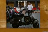 Pengunjung berjalan di antara skuter yang dipamerkan saat Scooter Contest di GOR Jayabaya, Kota Kediri, Jawa Timur, Sabtu (11/10/2025). Kontes skuter Vespa dengan 17 kategori tersebut merupakan bagian dari Kediri Scooter Festival #8 yang menjadi ajang berkumpulnya ribuan pecinta skuter Vespa dari berbagai daerah se-Indonesia selama tiga hari. Antara Jatim/Prasetia Fauzani/um
