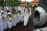 Pembimbing memberikan penjelasan kepada sejumlah siswa KB TK Al Maghfirah Surabaya saat manasik haji di Asrama Haji Sukolilo Surabaya, Surabaya, Jawa Timur, Selasa (21/10/2025). Kegiatan yang diikuti sekitar 90 siswa dari sekolah itu untuk mengenalkan tata cara pelaksanaan haji sejak usia dini kepada anak-anak. Antara Jatim/Didik Suhartono/um