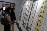 Pengunjung mengamati karya kaligrafi dan lukisan dari seniman Tiongkok yang dipajang dalam Pameran Seni Rupa Internasional di Graha Tumapel, Malang, Jawa Timur, Jumat (24/10/2025). Pameran tersebut diadakan hingga Sabtu (25/101) dengan menampilkan 80 karya seniman Indonesia dan Tiongkok serta digelar untuk mempererat jalinan persahabatan antar bangsa melalui seni rupa. Antara Jatim/Ari Bowo Sucipto/um