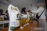 Warga mengambil bantuan pangan di Kelurahan Margadadi, Indramayu, Jawa Barat, Senin (10/11/2025). Pemkab Indramayu bersama Perum Bulog menyalurkan bantuan pangan untuk alokasi Oktober dan November kepada 200.621 Penerima Bantuan Pangan (PBP) dengan masing-masing penerima mendapatkan 20 kilogram beras dan empat liter minyak goreng. ANTARA FOTO/Dedhez Anggara/agr