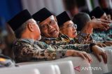 Wakil Presiden Indonesia Ke-10 dan 12 Jusuf Kalla (kanan) bersama Menteri Koordinator Bidang Pangan Zulkifli Hasan (kiri) dan Ketua Umum Pengurus Pusat Muhammadiyah Haedar Nashir (tengah) menghadiri Milad ke-113 Muhammadiyah di Halaman Kampus Muhammadiyah Bandung, Jawa Barat, Selasa (18/11/2025). Milad ke-113 Muhammadiyah yang bertemakan Memajukan Kesejahteraan Bangsa tersebut pengurus pusat Muhammadiyah sekaligus meluncurkan kartu elektronik keanggotaan Muhammadiyah. ANTARA FOTO/Raisan Al Farisi/agr