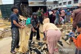 Warga mengumpulkan sepatu pascabanjir di Idi Rayeuk, Kabupaten Aceh Timur, Senin (1/12/2025) ANTARA/Hayaturrahmah