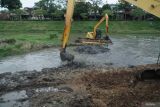 Pekerja mengoperasikan alat berat eksavator untuk mengeruk seimen di aliran Sungai Ngrowo, Tulungagung,  Jawa Timur, Selasa (2/12/2025). Normalisasi sungai dilakukan untuk mencegah pendangkalan yang berpotensi memicu banjir dalam kota saat penghujan. ANTARA Jatim/Destyan Sujarwoko/mas.