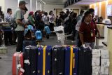 Calon penumpang pesawat antre di area lapor diri sebelum melakukan penerbangan di Bandara Internasional Juanda Surabaya di Sidoarjo, Jawa Timur, Senin (29/12/2025). Pengelola Bandara Juanda mencatat, selama pelaksanaan Posko Terpadu Angkutan Natal 2025 dan Tahun Baru 2026 (Nataru) per 28 Desember telah melayani sekitar 590.000 penumpang dan 4.000 an pergerakan pesawat dengan arus puncak penumpang pada Rabu (24/12) sebanyak 48.364 orang. Antara Jatim/Umarul Faruq