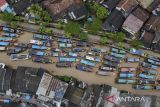 Foto udara ratusan kapal nelayan bersandar saat tidak melaut di Labuan, Pandeglang, Banten, Kamis (15/1/2026). Nelayan setempat mengaku sejak seminggu terakhir sudah tidak melaut akibat adanya cuaca buruk disertai gelombang tinggi dan angin kencang yang terjadi di perairan Selat Sunda. ANTARA FOTO/Muhammad Bagus Khoirunas/gp