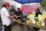 Warga membeli paket sembako berharga murah di Koperasi Kelurahan Merah Putih (KKMP) Ngronggo, Kota Kediri, Jawa Timur, Rabu (18/3/2026). Program tebus murah kebutuhan pokok meliputi beras SPHP kemasan 5 kilogram, gula pasir 1 kilogram, minyak goreng 1 liter, mie instan 4 bungkus seharga Rp100 ribu per pakat dan gratis takjil tersebut guna membantu masyarakat mendapatkan kebutuhan pokok terjangkau menjelang Lebaran sekaligus sebagai upaya menarik anggota baru KKMP. ANTARA Jatim/Prasetia Fauzani/mas.