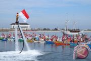 PENGIBARAN BENDERA PANTAI LOSARI