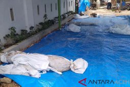 Kuburan massal korban tsunami dipindahkan