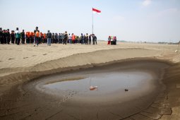 Pelajar NU Sidoarjo upacara bendera di kolam penampungan lumpur