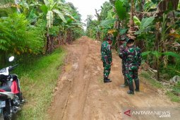 TMMD bangun jalan membuat senyum petani sumringah
