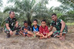 Prajurit TMMD bercanda bersama anak-anak