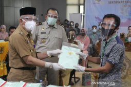 HST Regent hands over 574 land certificates