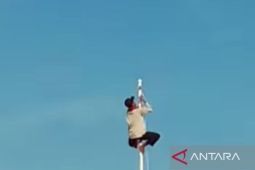 Ketua RT  panjat tiang bendera saat upacara HUT kemerdekaan