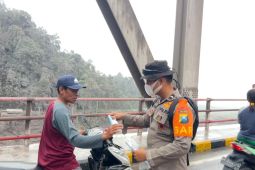 East Java police hand out masks as Mount Semeru ash spreads