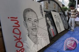 Ade Komarudin Beli Lukisan Bergambar Jokowi