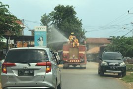 Gunakan Damkar,  Antam lakukan penyemprotan cairan disinfektan