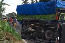 2  truk tabrakan, bikin mobil pick up terguling saat menghindar