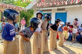 Helm lindungi pembalap karung lomba "Agustusan"