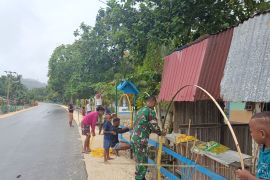 Posramil Warsa membantu warga membuat hiasan Natal di sepanjang jalan