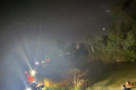 Firefighters dive into river to fill water to extinguish fires